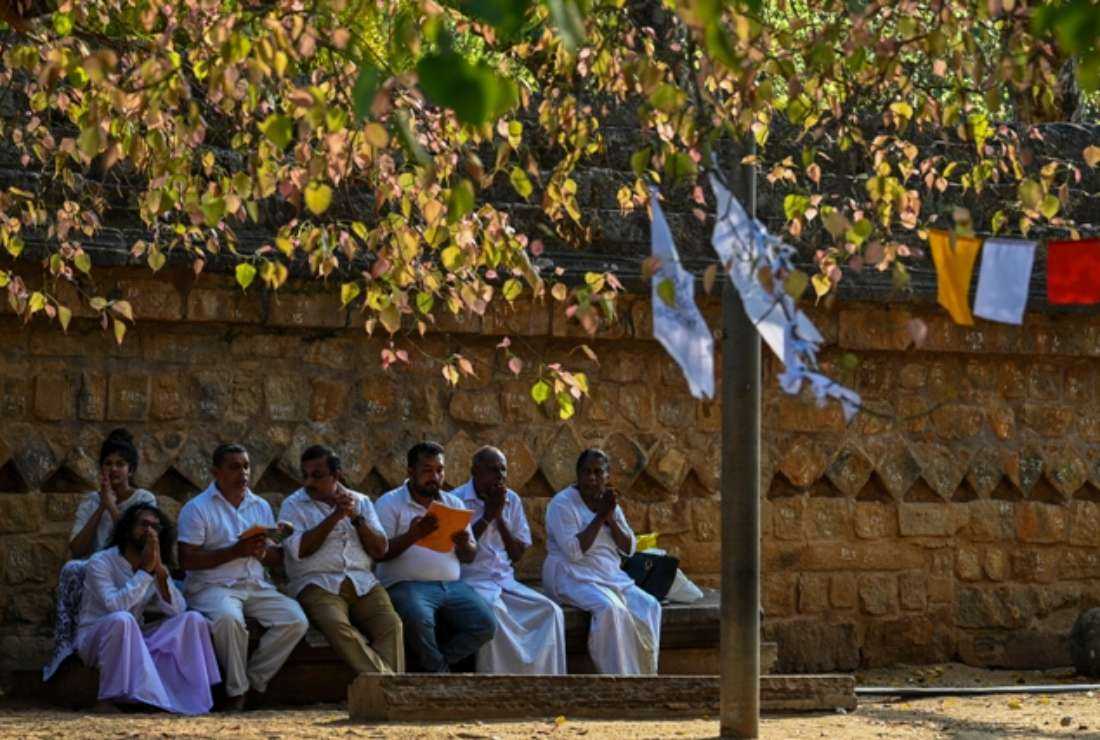 Devotees offer prayers at the Sri Maha Bodhi temple in the north-central town of Anuradhapura on May 19. Sri Lanka is officially a Buddhist country and religious leaders, rights activists and civil society organizations are warning against ethnic and religious divisions ahead of next year's presidential election