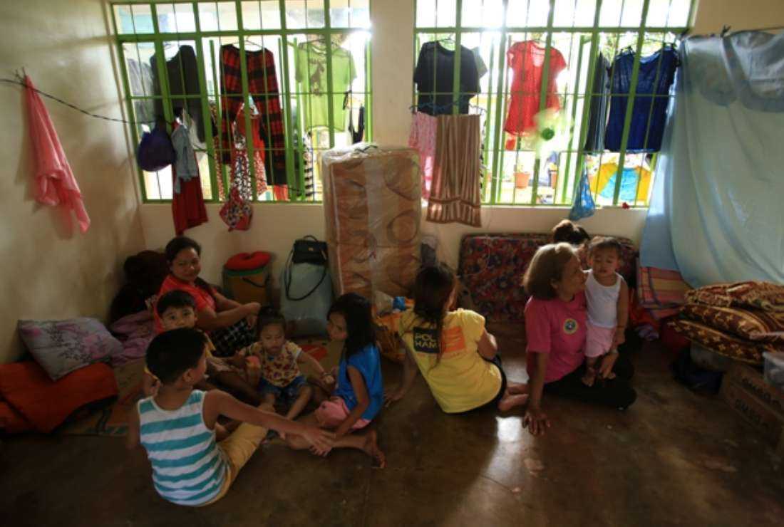People rest inside the Gabawan elementary school, used as an evacuation center following increased seismic activity from nearby Mayon volcano, in Daraga, Albay province on June 11. Thousands of people living near the Philippine volcano have taken shelter in evacuation centers as officials warned of health risks from ash and toxic gases spewing from the rumbling crater