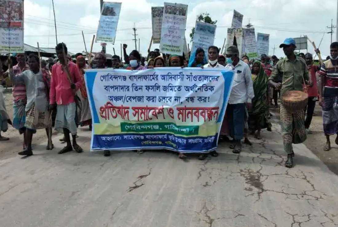 Hundreds of ethnic Santals take to the streets in the Gobindaganj area of Gaibandha district on Aug. 29, 2021, to demand the cancellation of a government plan for a special economic zone on their ancestral land
