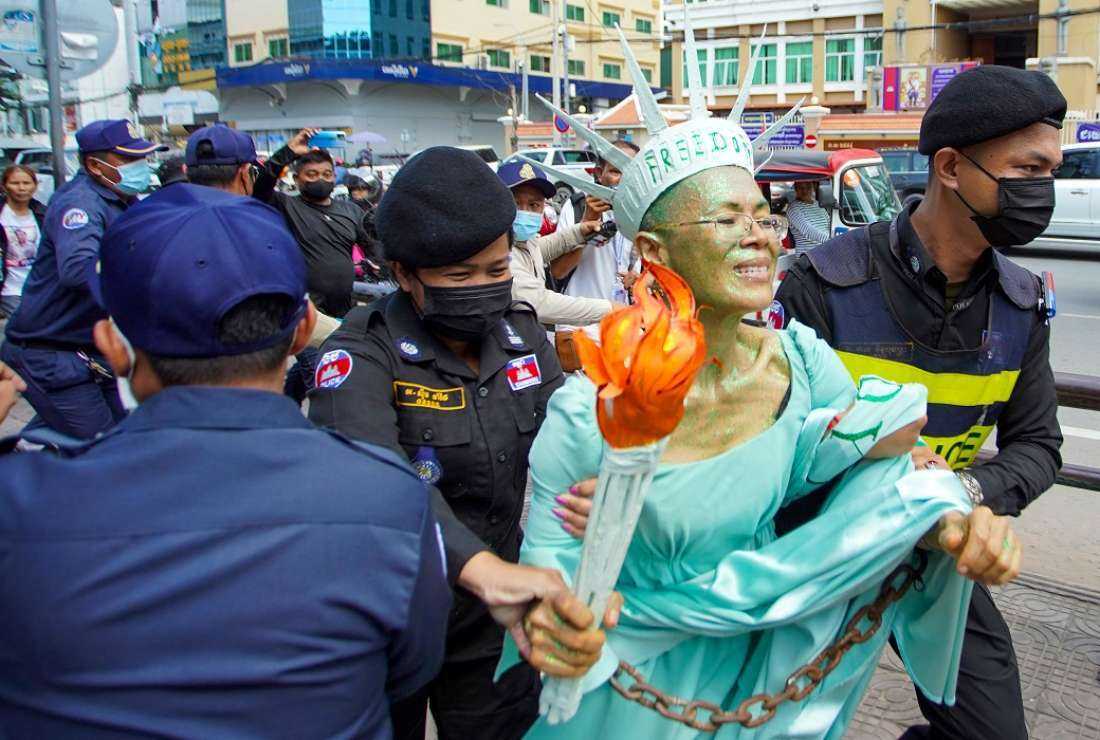 Cambodian-US human rights advocate, Theary Seng, dressed as Lady Liberty, is arrested by police after being found guilty of treason in her trial in front of the Phnom Penh municipal court on June 14, 2022