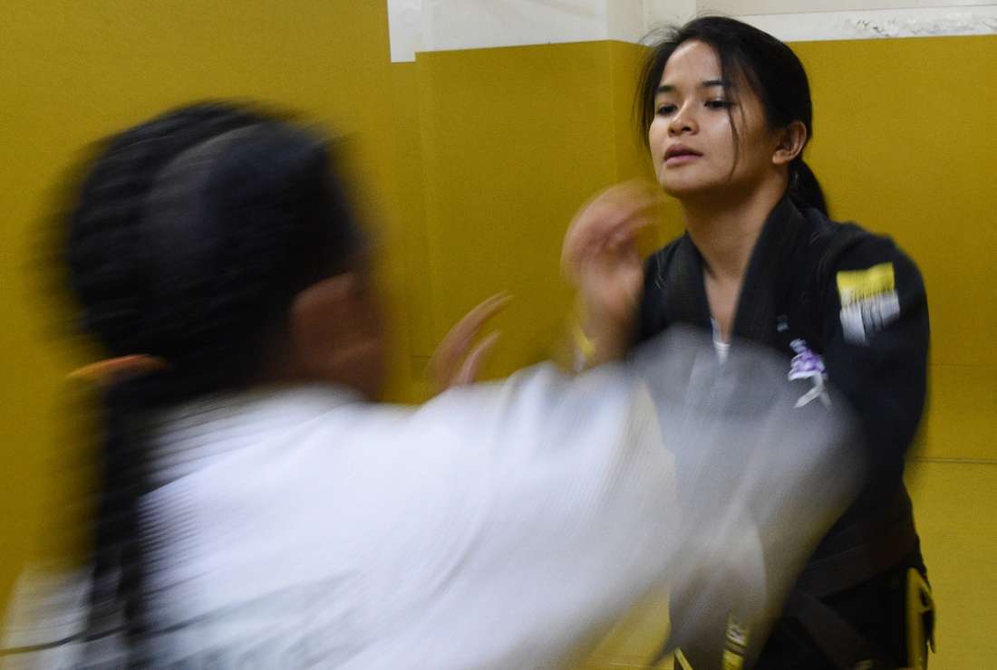 Jiu-jitsu world champion Meggie Ochoa spars with a young opponent at a gym in Manila. Ochoa teaches self-defense to victims of sexual abuse in a bid to give them tools to recover from trauma and to protect themselves in the future