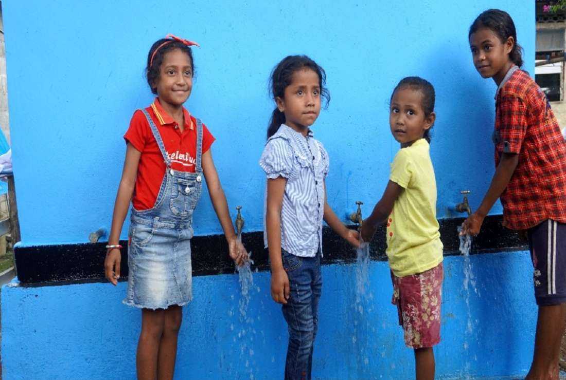 Timorese children enjoy clean water after the service was inaugurated in Railaco, Ermera municipality in October