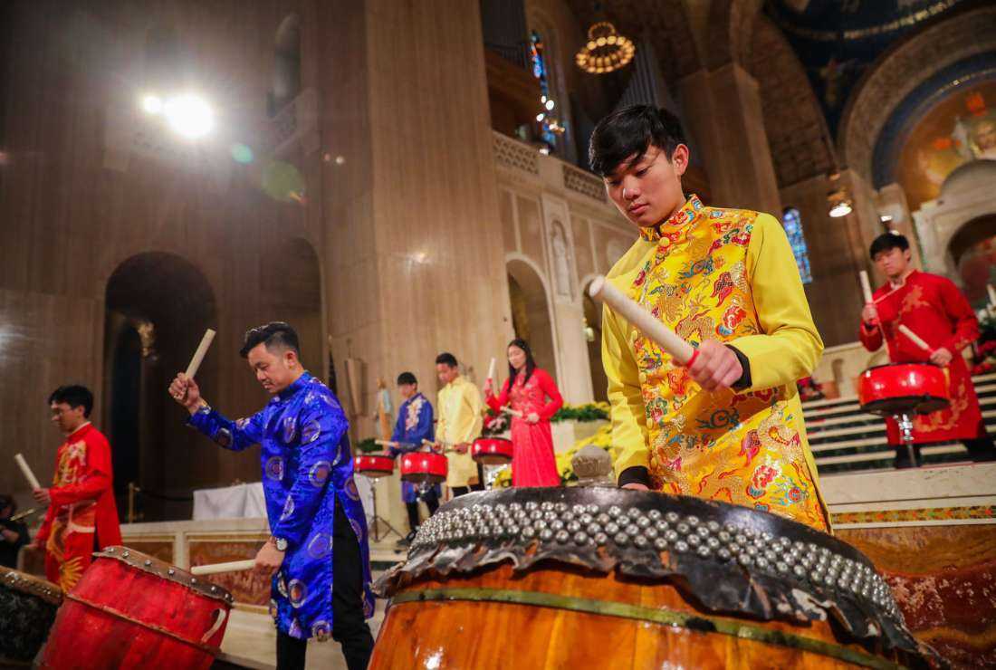 Members of the youth group from Our Lady of Vietnam Parish in Silver Spring, Maryland, play traditional drums to welcome pilgrims at the beginning of the 19th Asian and Pacific Island Catholics’ Marian Pilgrimage to the Basilica of the National Shrine of Immaculate Conception on May 7, 2022