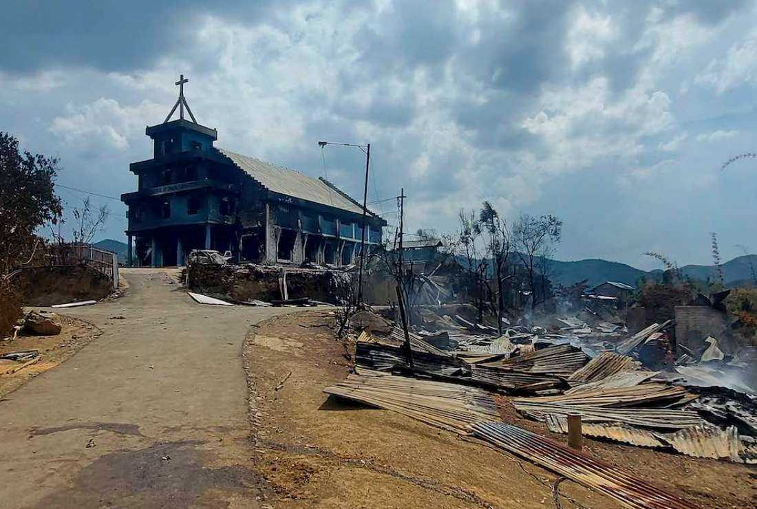 The remains of a burnt church (left) and houses (right) are seen in Langching village some 45 km from Imphal on May 31 during ongoing ethnic violence in India's northeastern Manipur state