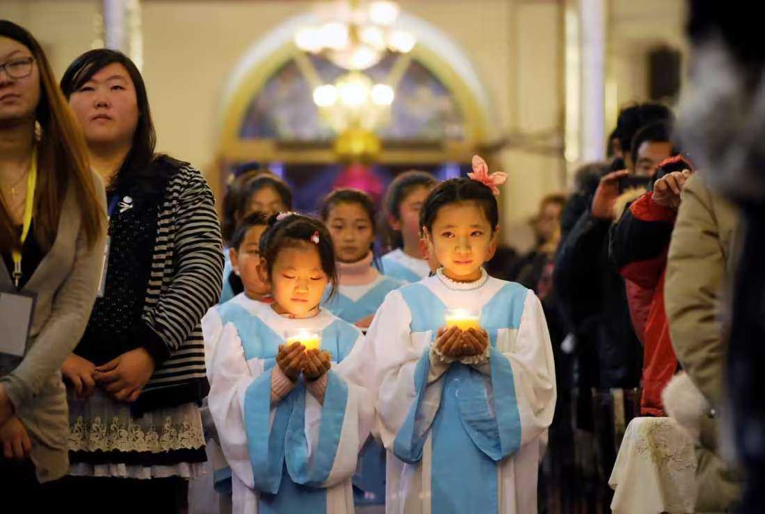 Catholics attend a Mass in a church in China in this file image. A Chinese academic has published a book on the history and evolution of Catholic dioceses in China