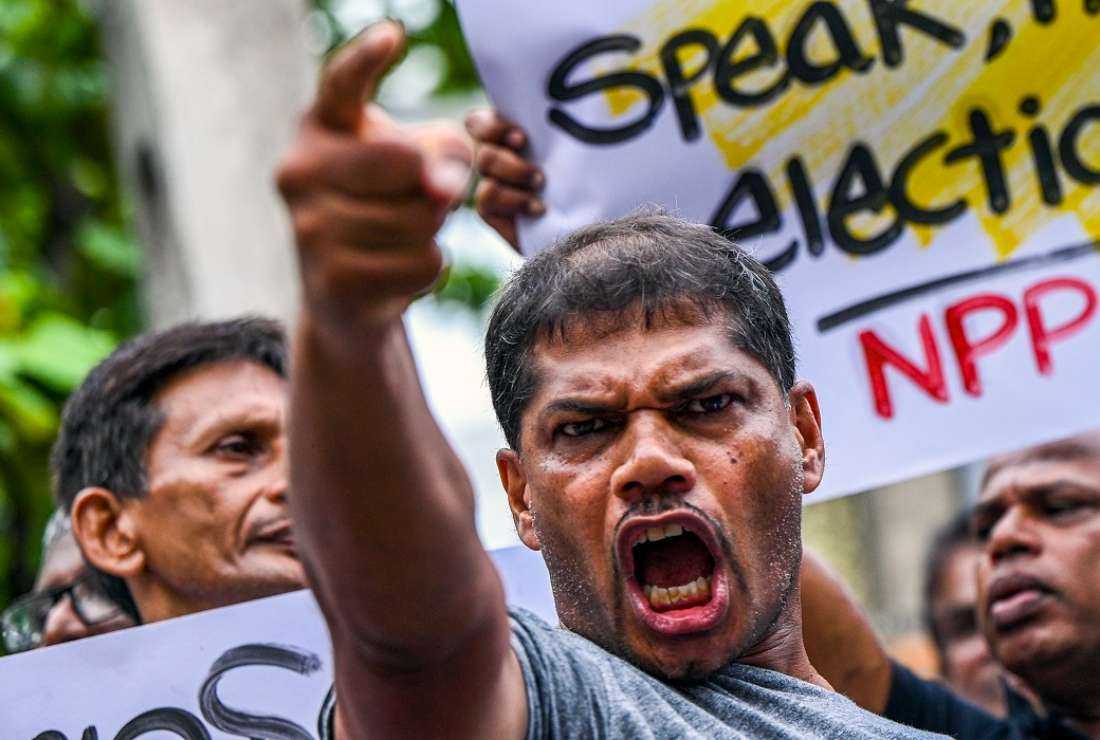 Anti-government demonstrators protest as they demand the holding of local elections, near the Election Commission in Colombo on June 8, 2023
