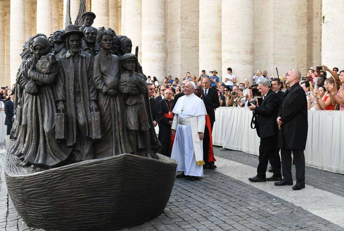 Pope Francis (center) attends the unveiling of a sculpture called 'Angels Unaware' by Canadian sculptor Timothy P. Schmalz (right) depicting a group of 140 migrants of various cultures and from different historic times, following a mass for World Day of Migrants and Refugees on Sept. 29, 2019, at St. Peter's Square in the Vatican