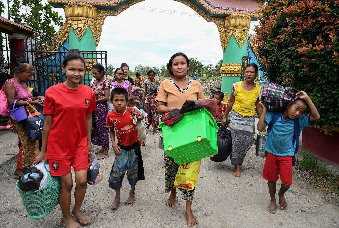 People arrive to take shelter at a monastery in Sittwe town in Myanmar’s Rakhine state on May 12 ahead of the expected landfall of Cyclone Mocha
