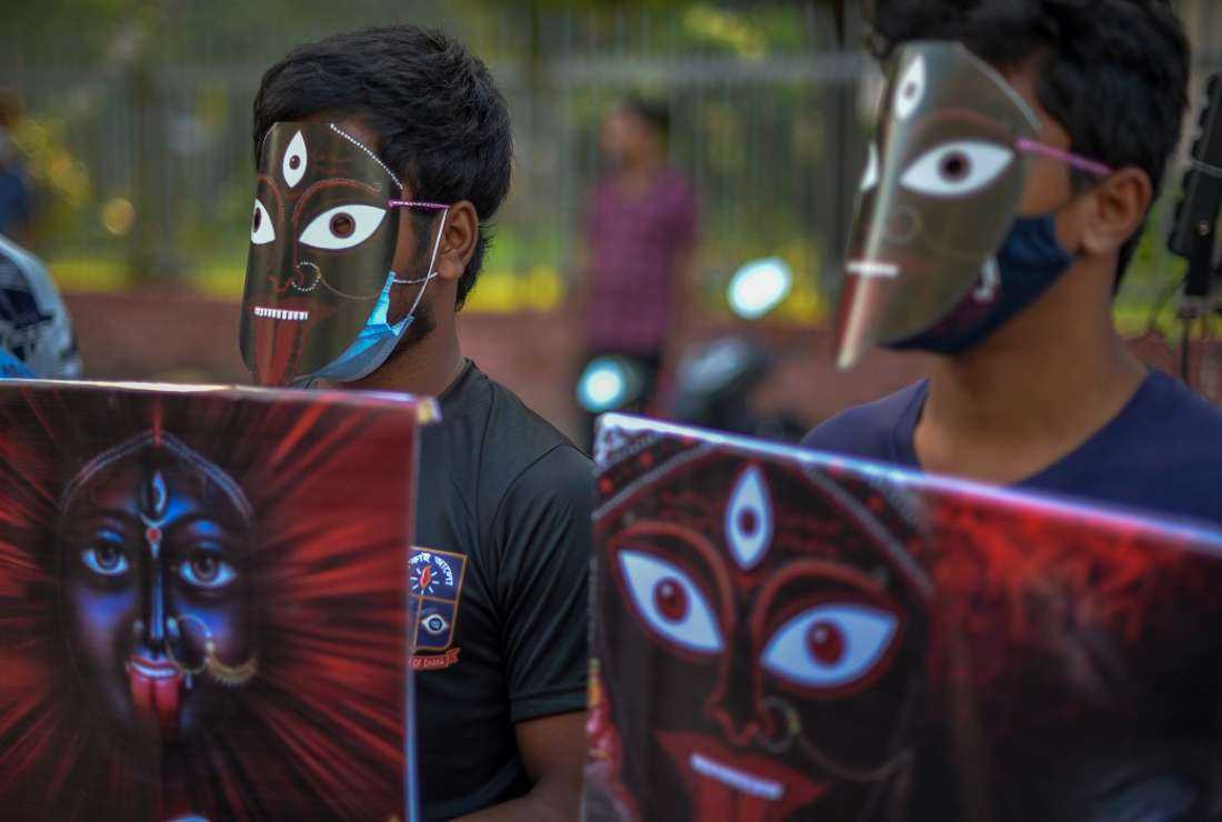 Social activists wearing masks hold placards during a protest against religious violence against the Hindu community in Bangladesh, in Dhaka on Nov. 4, 2021