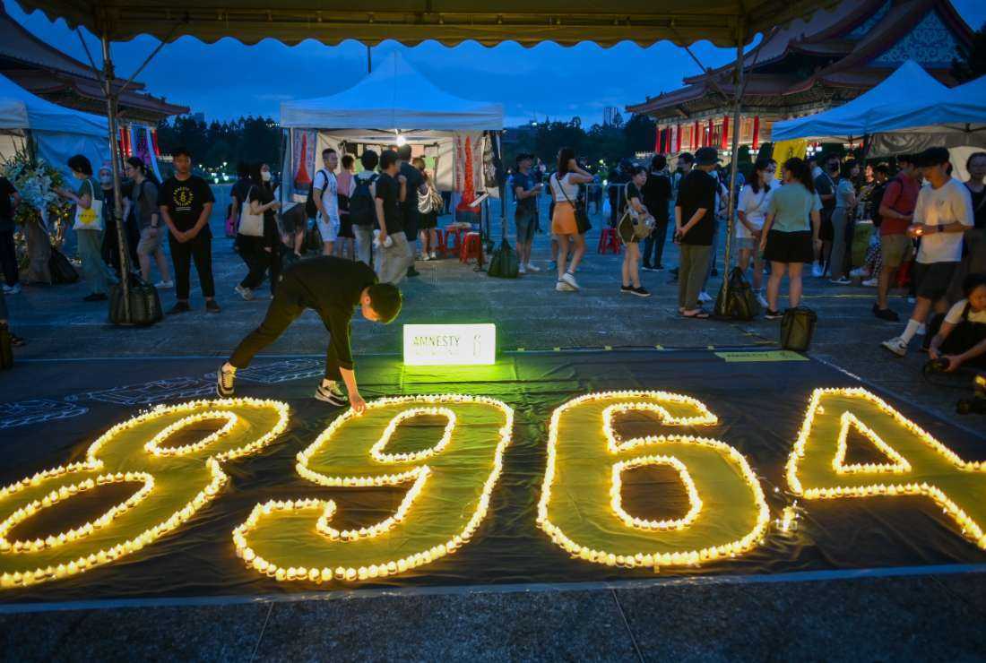A man puts a candle at the Liberty Square of the Chiang Kai-shek Memorial Hall to mark the 34th anniversary of Beijing Tiananmen crackdown in 1989, in Taipei on June 4