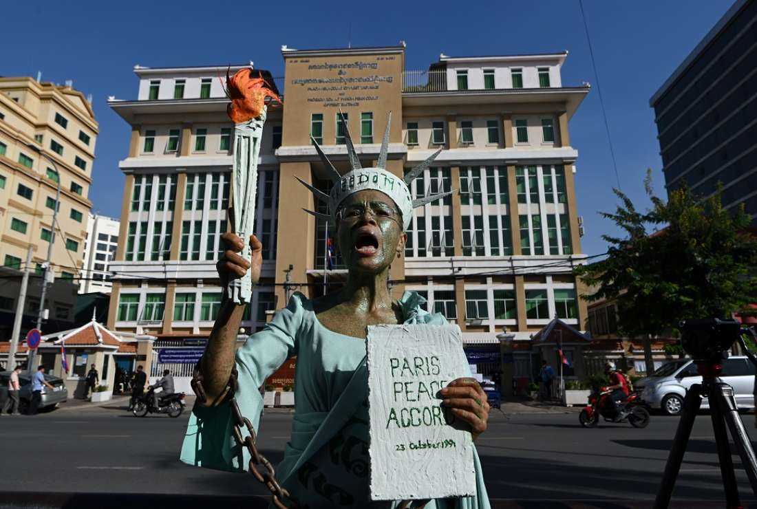 Cambodian-American human rights advocate Theary Seng, dressed as Lady Liberty, shouts slogans in front of Phnom Penh municipal court on June 14, 2022