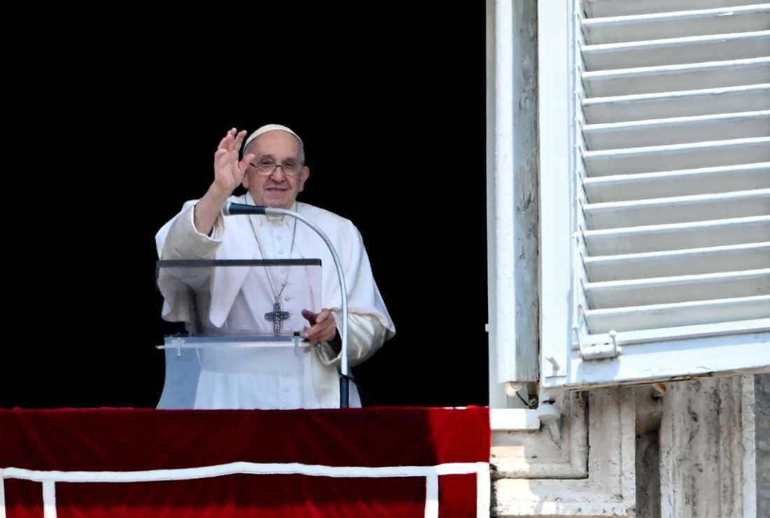 Pope Francis addresses the crowd from the window of the apostolic palace overlooking St Peter's Square during the Angelus prayer in the Vatican on June 18