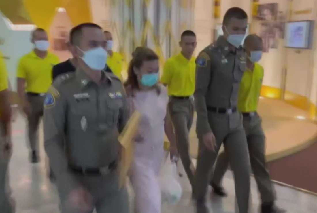 This screen grab taken on April 28 from handout video footage from Thai PBS via AFPTV shows police escorting suspect Sararat Rangsiwuthaporn (center) from a police station in Bangkok on April 26