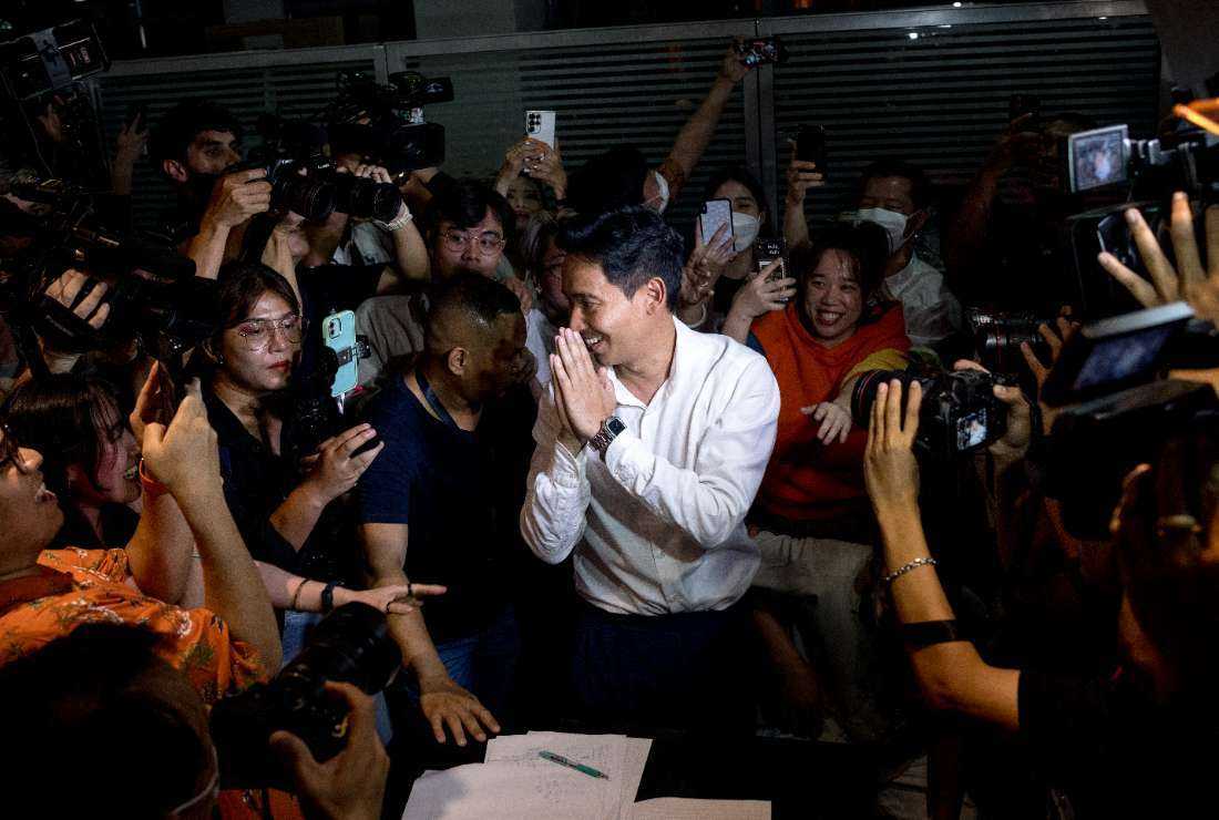 Move Forward Party leader and prime ministerial candidate Pita Limjaroenrat (center) leaves the party’s headquarters as votes continue to be counted, during Thailand's general election in Bangkok on May 14