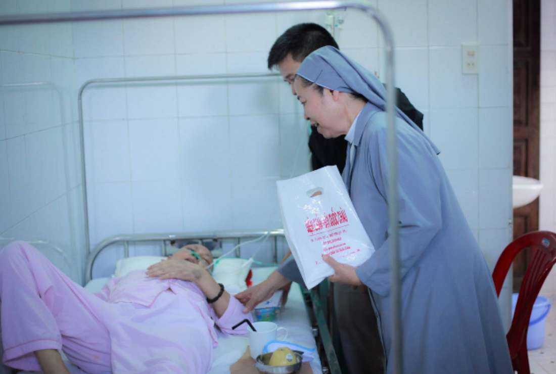 St. Paul de Chartres Sister Rose Ngo Thi Kim Thanh and a volunteer visit a patient at the Psychiatric Hospital in Hue on April 22