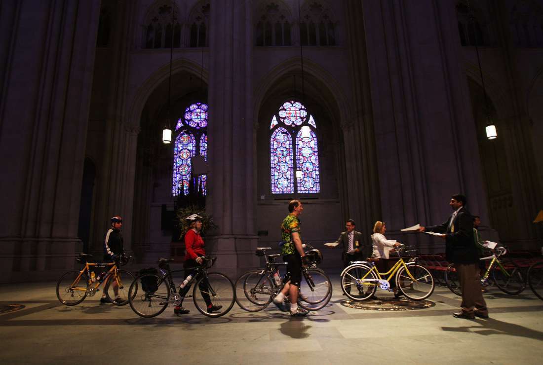 Cyclists walk into the Cathedral of St. John the Divine during the 11th annual 'Blessing of the Bicycles' on April 18, 2009, in New York City. The event features a bicycle-themed prayer and the sprinkling of holy water on dozens of bicycles to start off a safe season of cycling